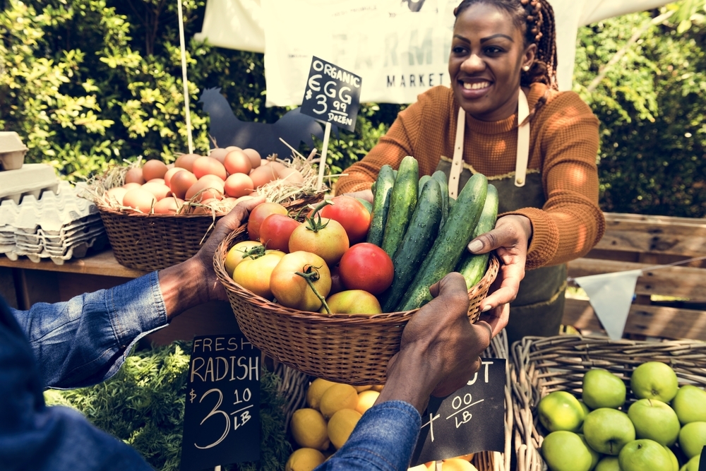 Woman Selling Fresh Local Vegetable at Farmers Market Woman Selling Fresh Local Vegetable at Farmers Market