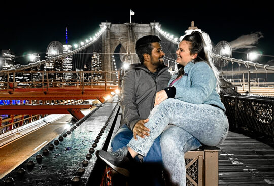 Living as digital nomads in New York City, Landing members Madison and Ivan pose on the Brooklyn Bridge