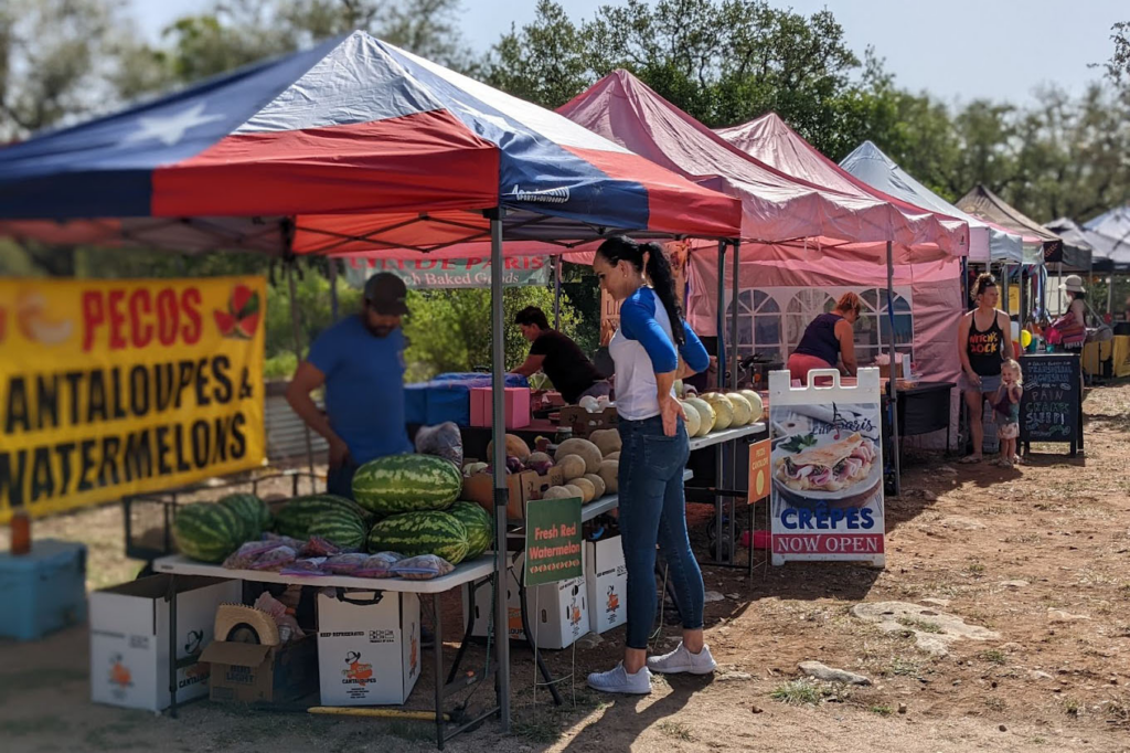 Woman buying from a stand at Pedernales Farmers' Market