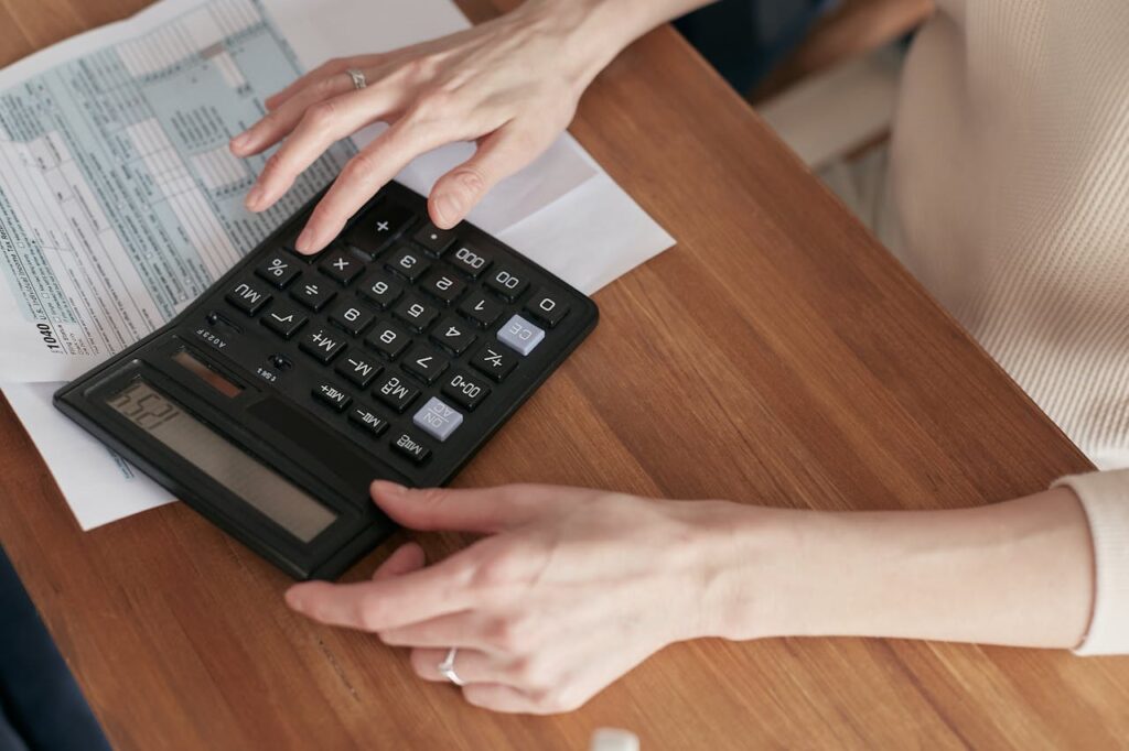 person using a calculator do the their taxes
