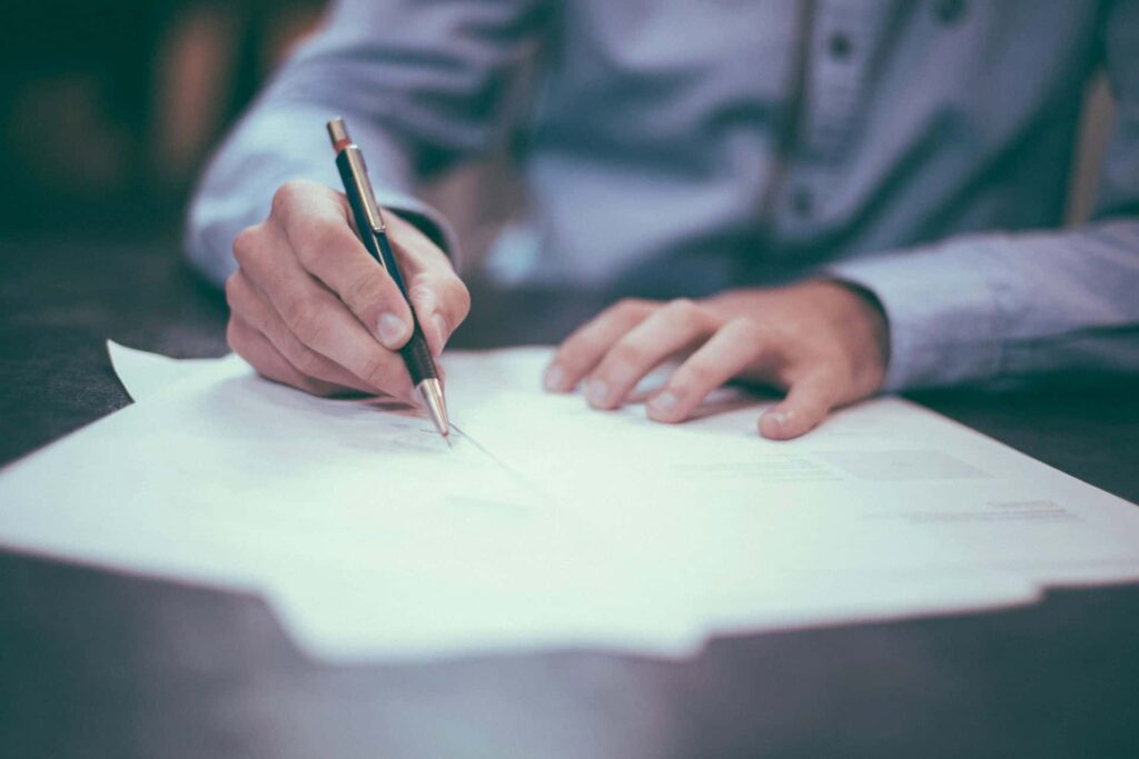 person signing a moving insurance