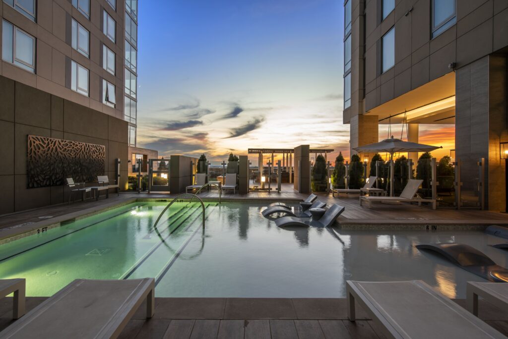 Luxury Landing stay in Atlanta with rooftop pool at sunset.