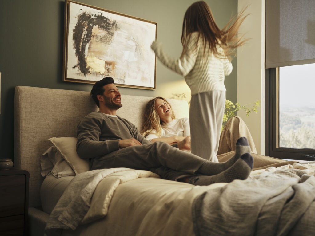 Happy family in bed in a comfortable stay
