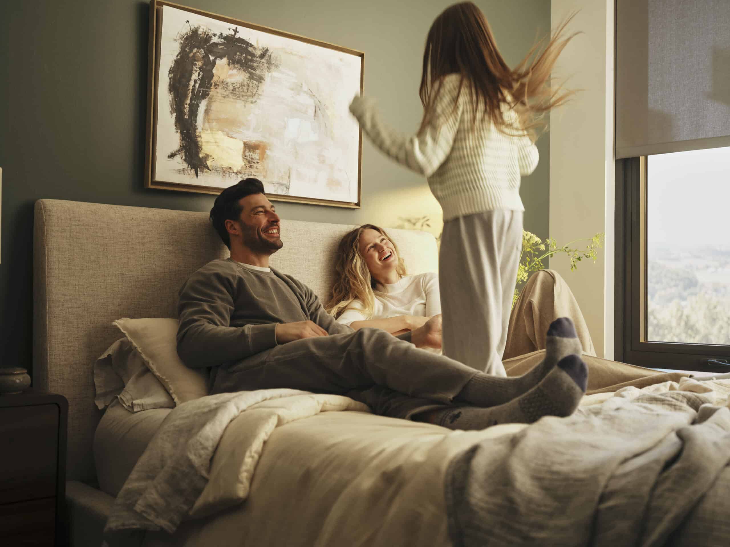 Happy family in bed in a comfortable stay