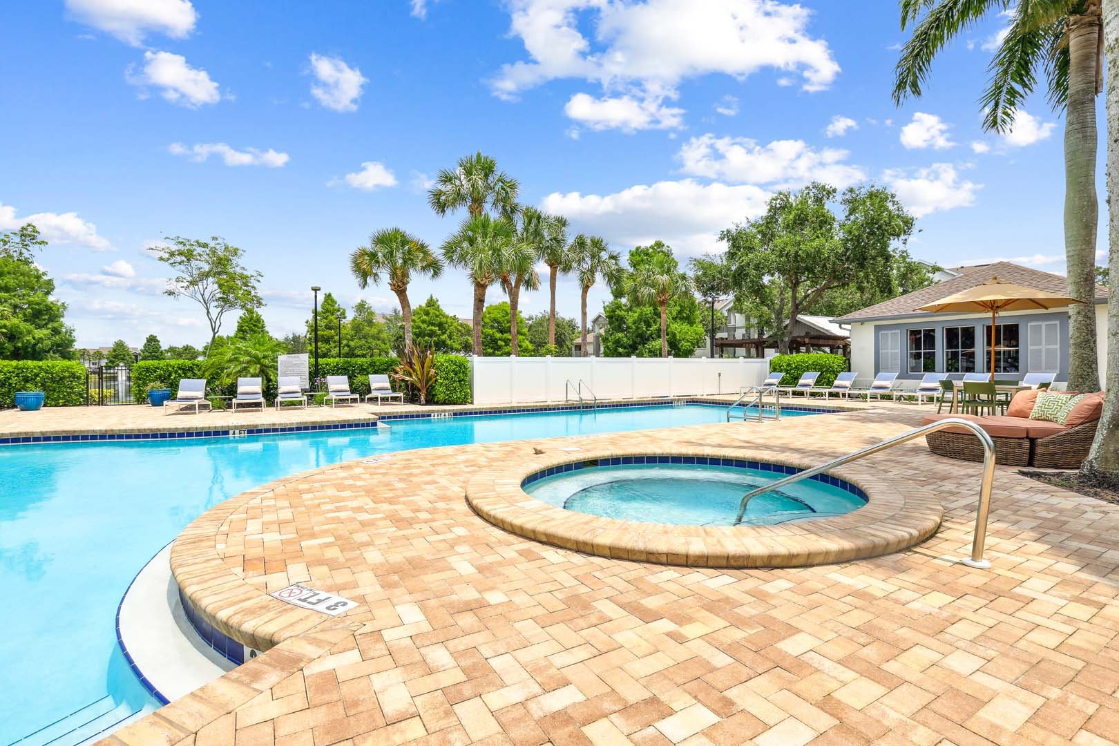 Palm-lined pool at Halston Lakeside in Sarasota, Florida